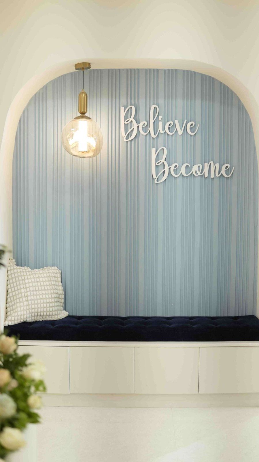 Seating nook with a 'Believe, Become' sign